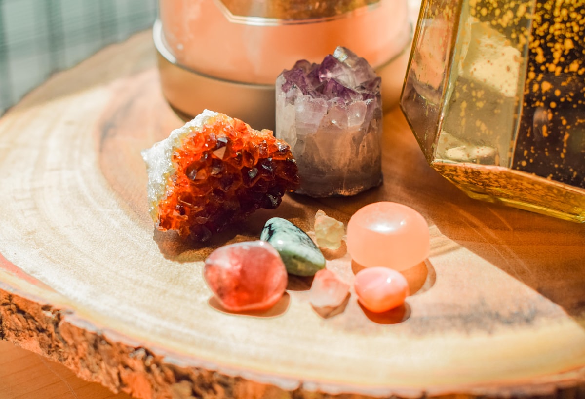 Crystals carry steady frequencies of their own; in a Crystal Reiki session they help hold and direct the work. Citrine, amethyst, and rose quartz gathered on a wooden altar beside a salt lamp