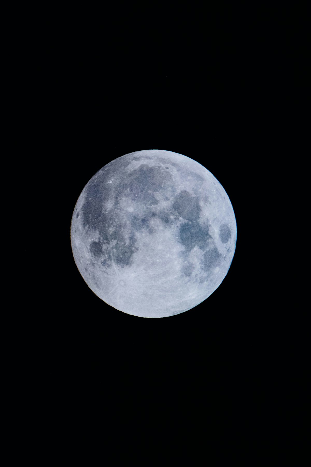 A luminous full moon in a black sky